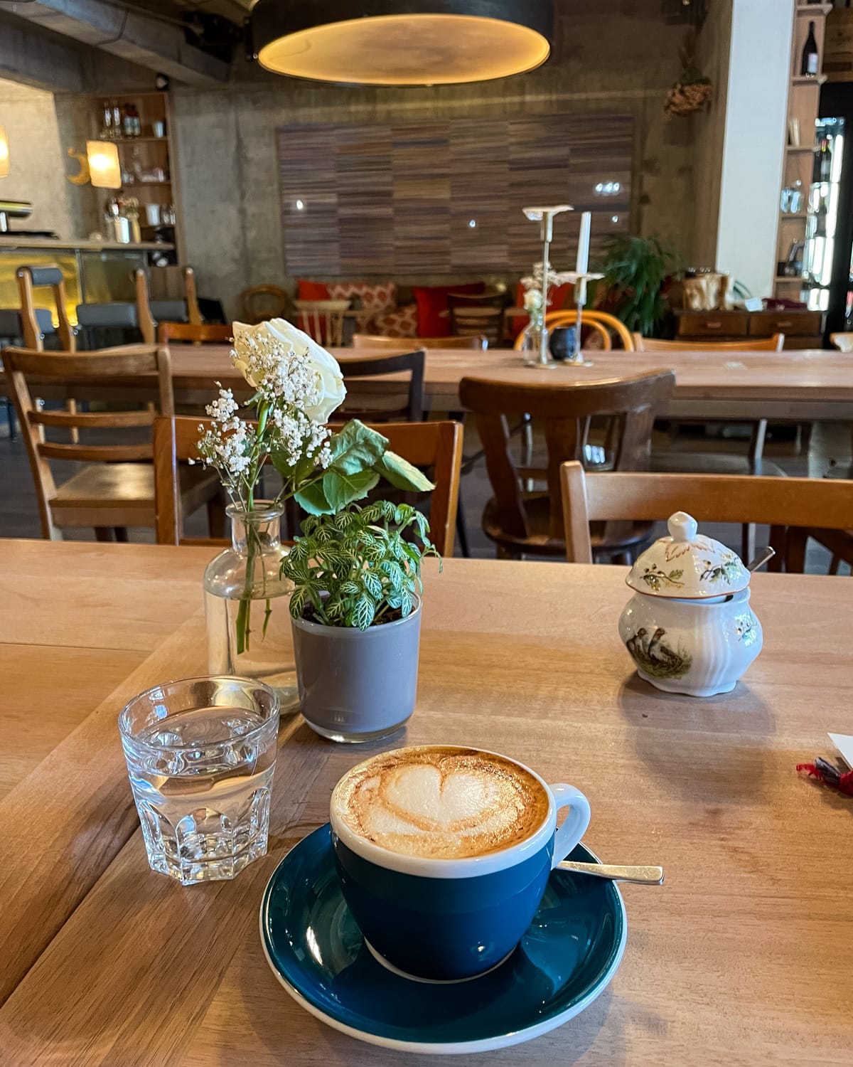 Latte on wooden table at Manud Cafe