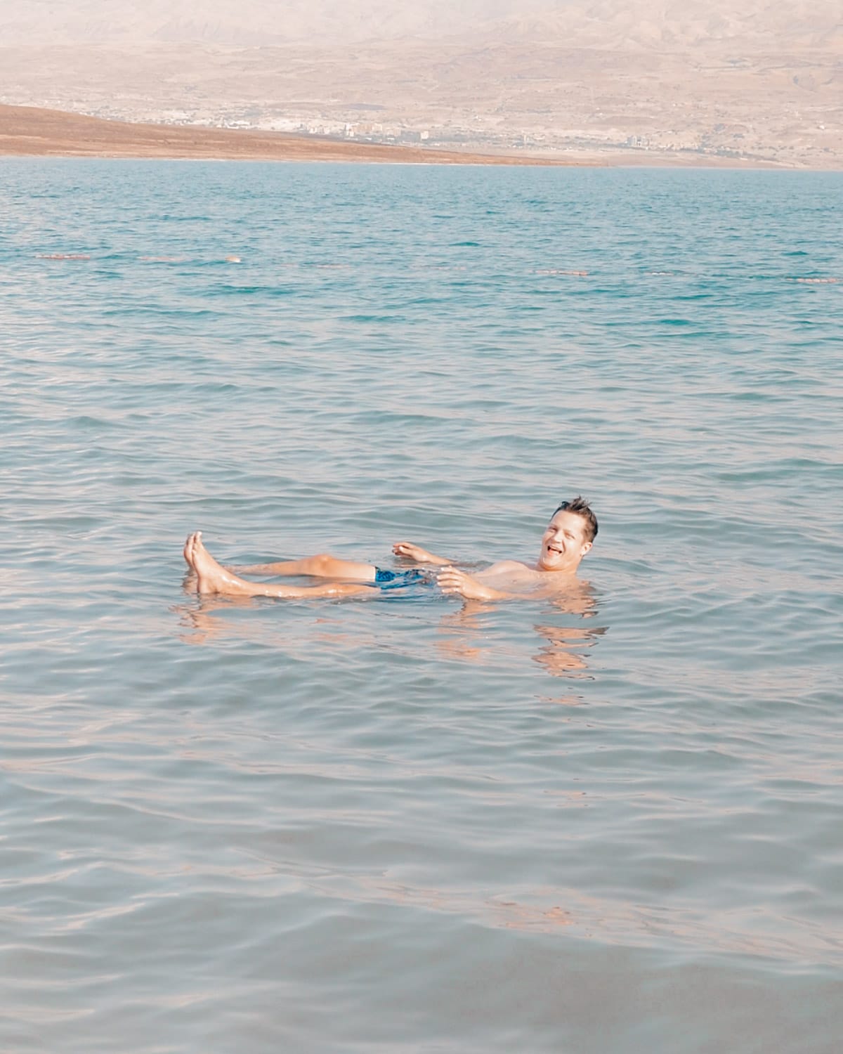 Ari, with brown hair and brown eyes, swimming in the Dead Sea