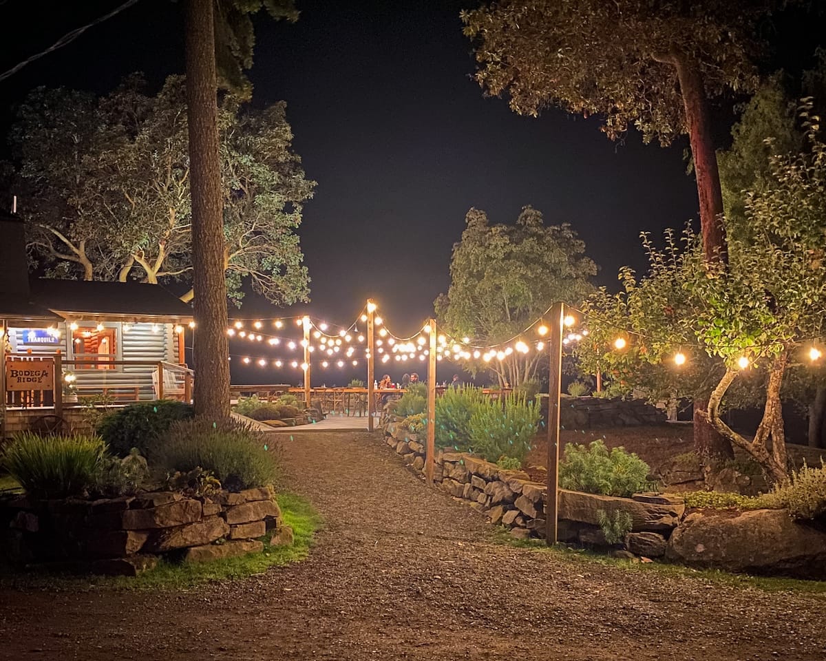  Lola restaurant at Bodega Ridge, a rustic wooden cabin adorned with fairy lights, exuding a warm and inviting atmosphere.