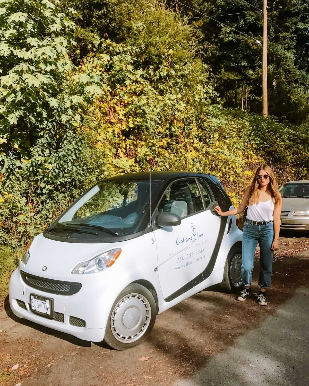 White Galiano Inn car parked near forested scenery, ideal for getting around the island.