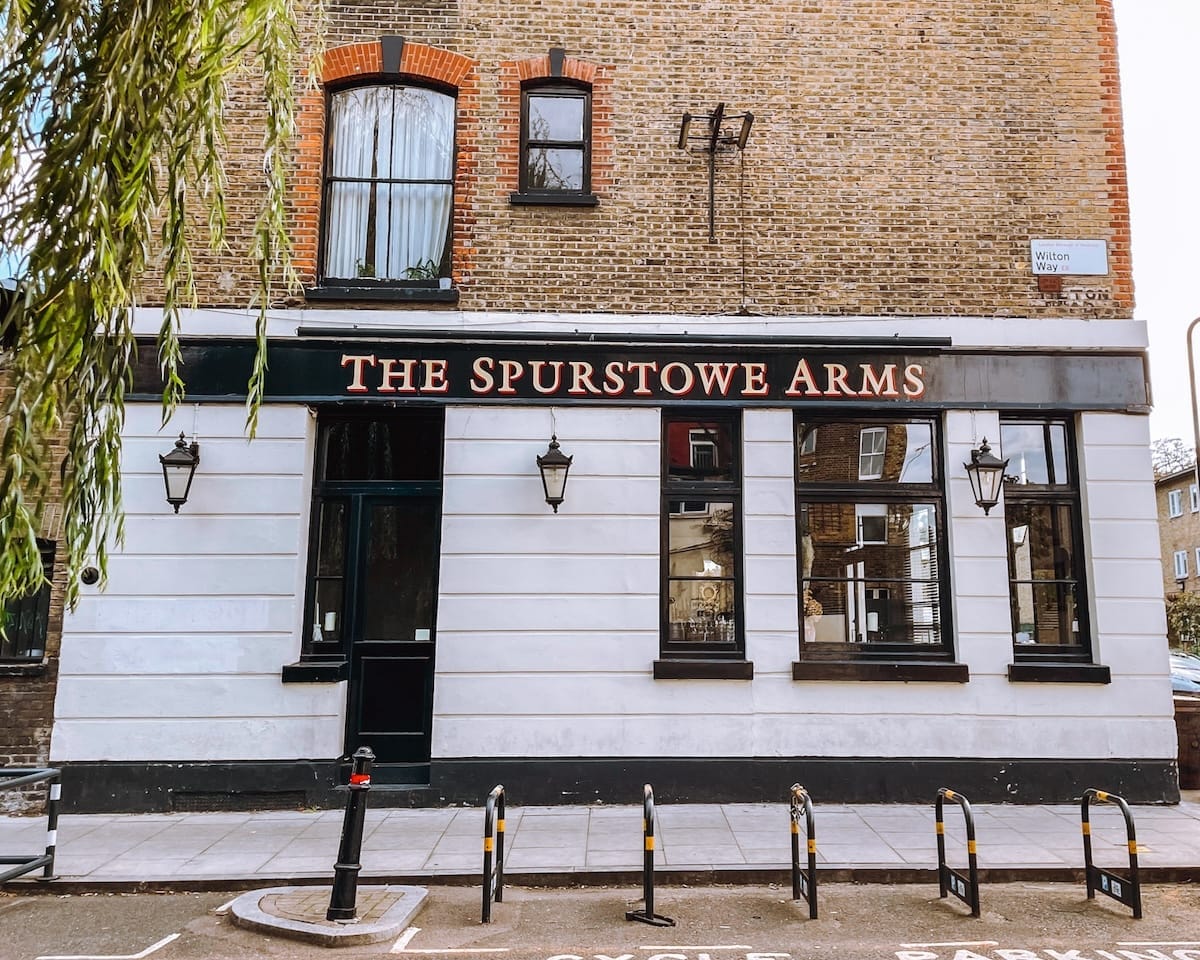 The Spurstowe Arms, a classic London pub with a white façade and black trim.