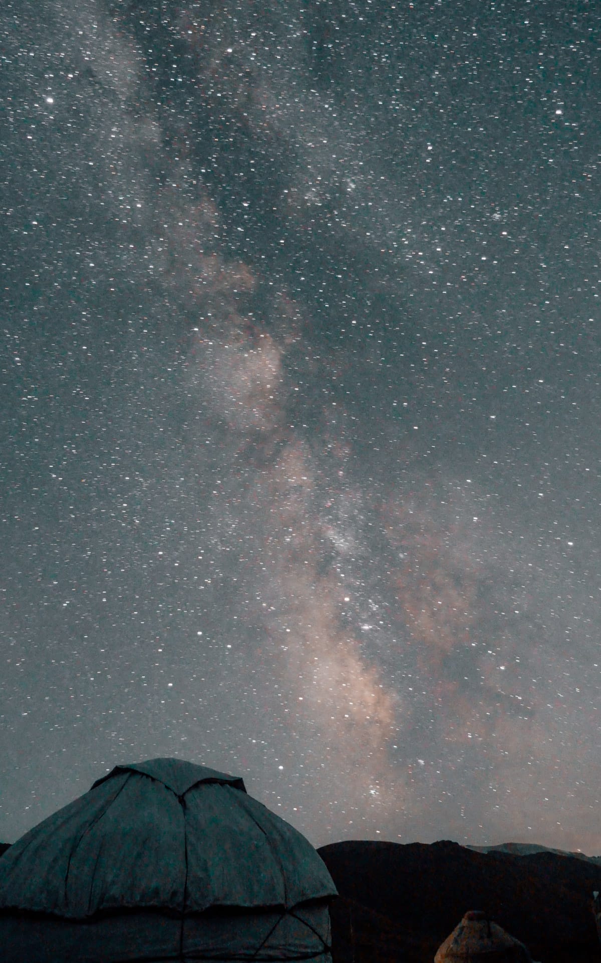 The Milky Way galaxy visible over yurts in Kel-Suu's dark sky, creating a stunning stargazing experience.