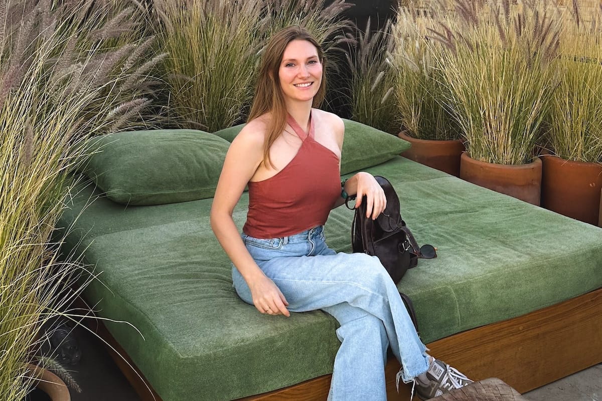 Cecily, founder and travel writer of Groovy Mashed Potatoes, sitting on an outdoor chez lounge in Oaxaca.